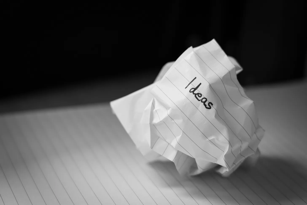 image of crumpled paper with ideas written on it